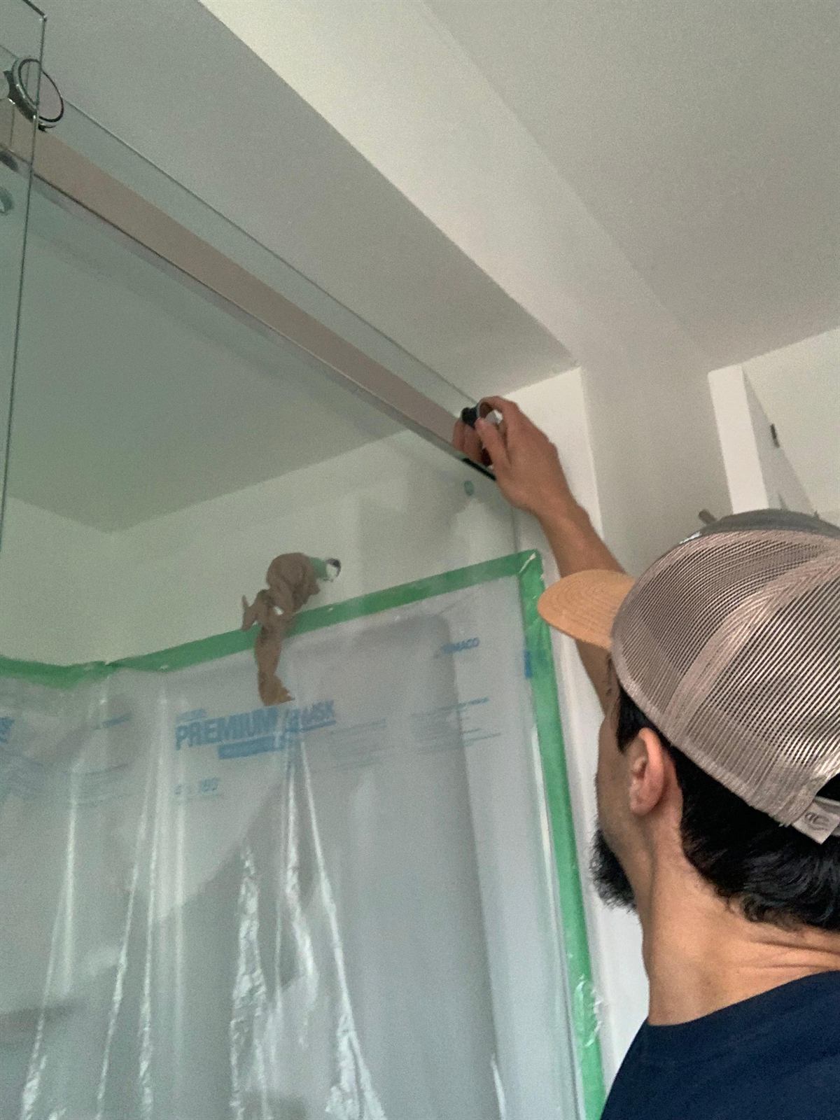Meticulous wall painting using protective plastic containment to keep the home clean